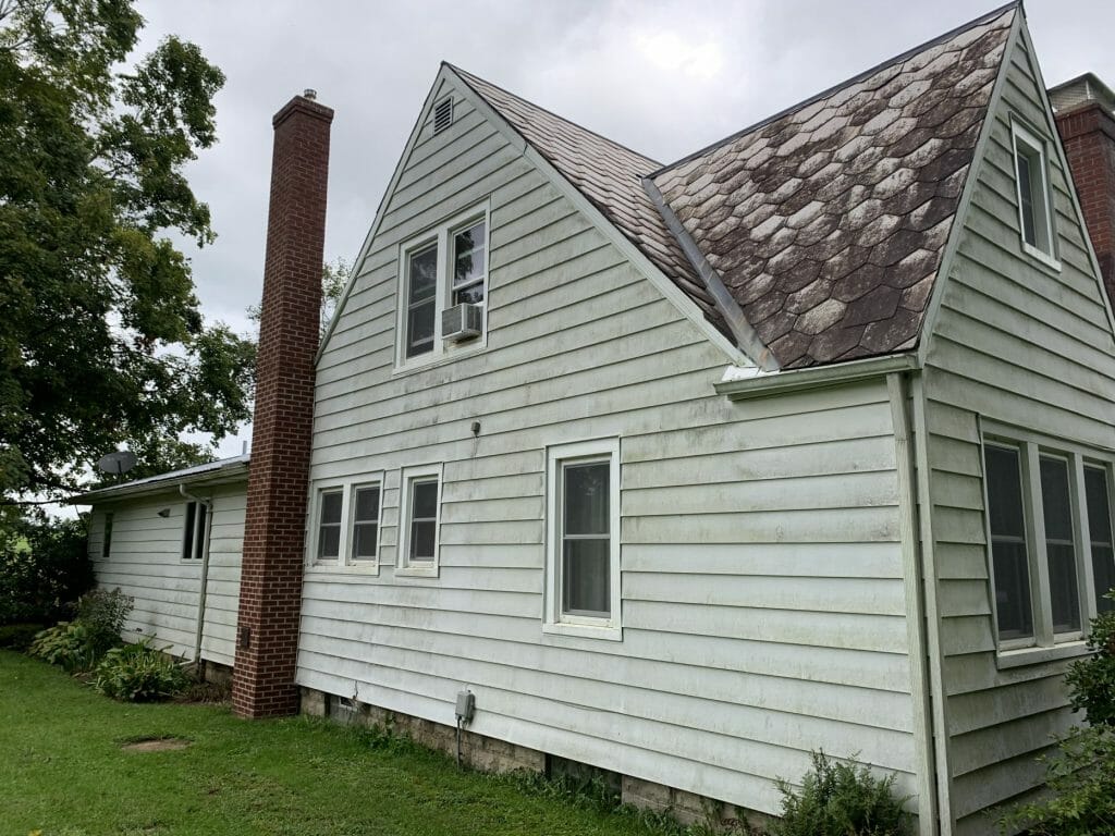 Gutters before K-Guard was installed on this stone and siding