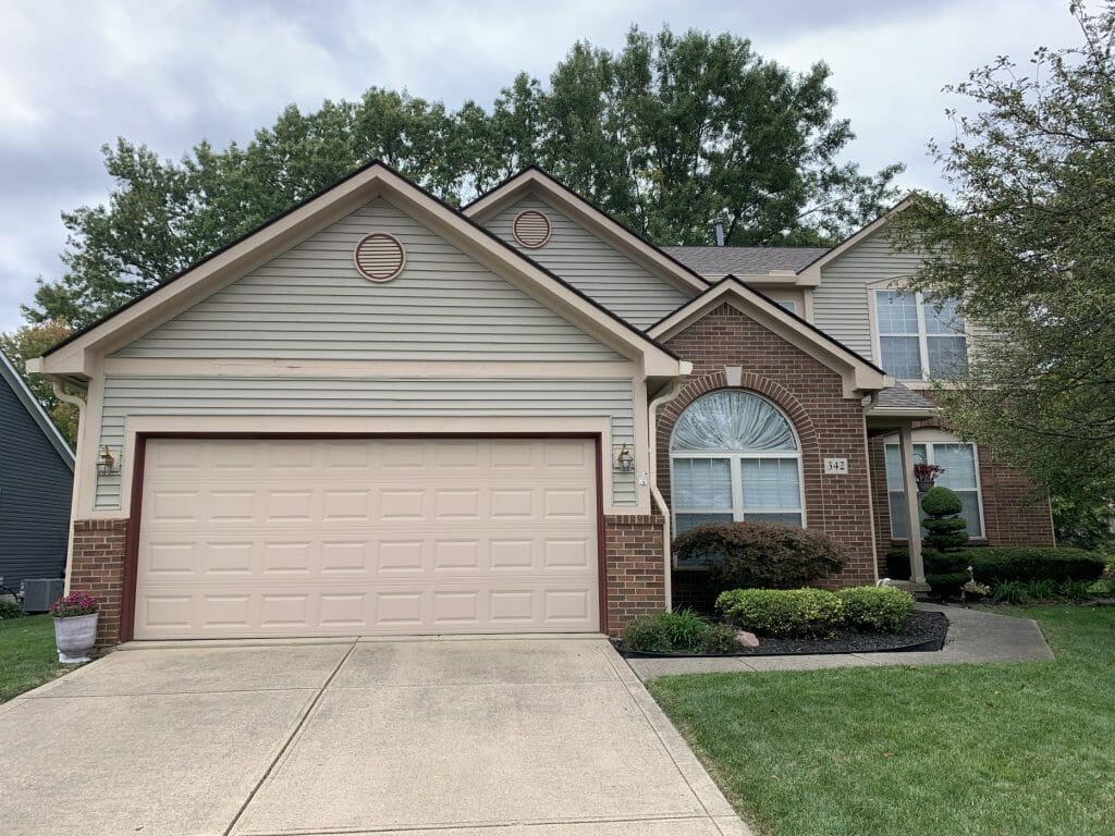 The same tan two-story after K-Guard was installed
