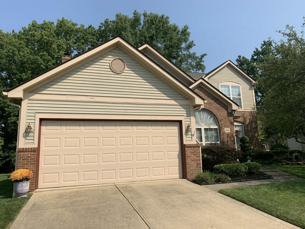 Gutters before K-Guard was installed on this tan two-story