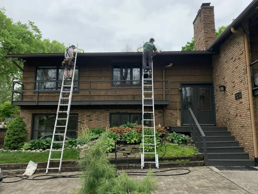 K-Guard installers on ladders fitting a new gutter system