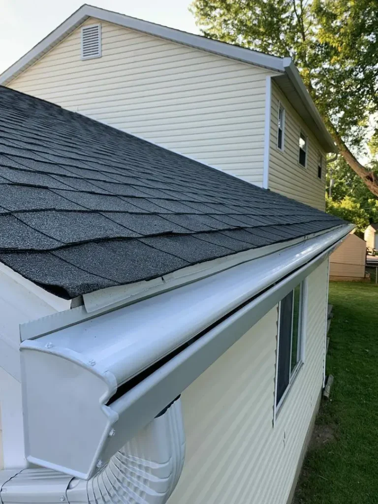 Close-up of a black K-Guard hood and downspout elbow