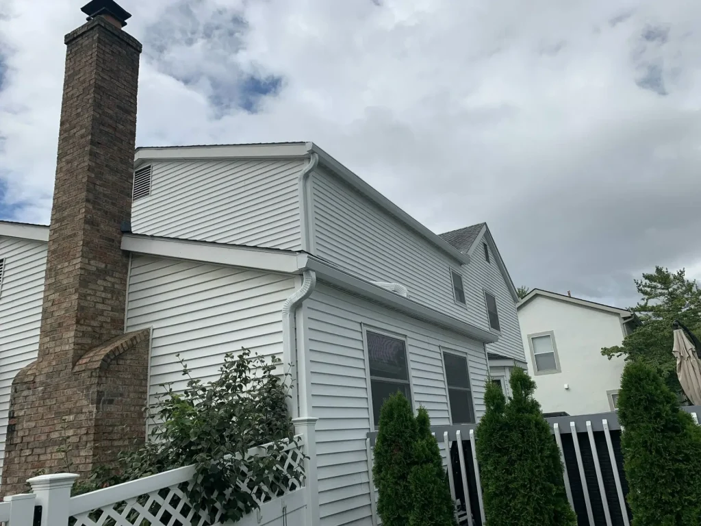 White two-story home with K-Guard gutters and downspouts
