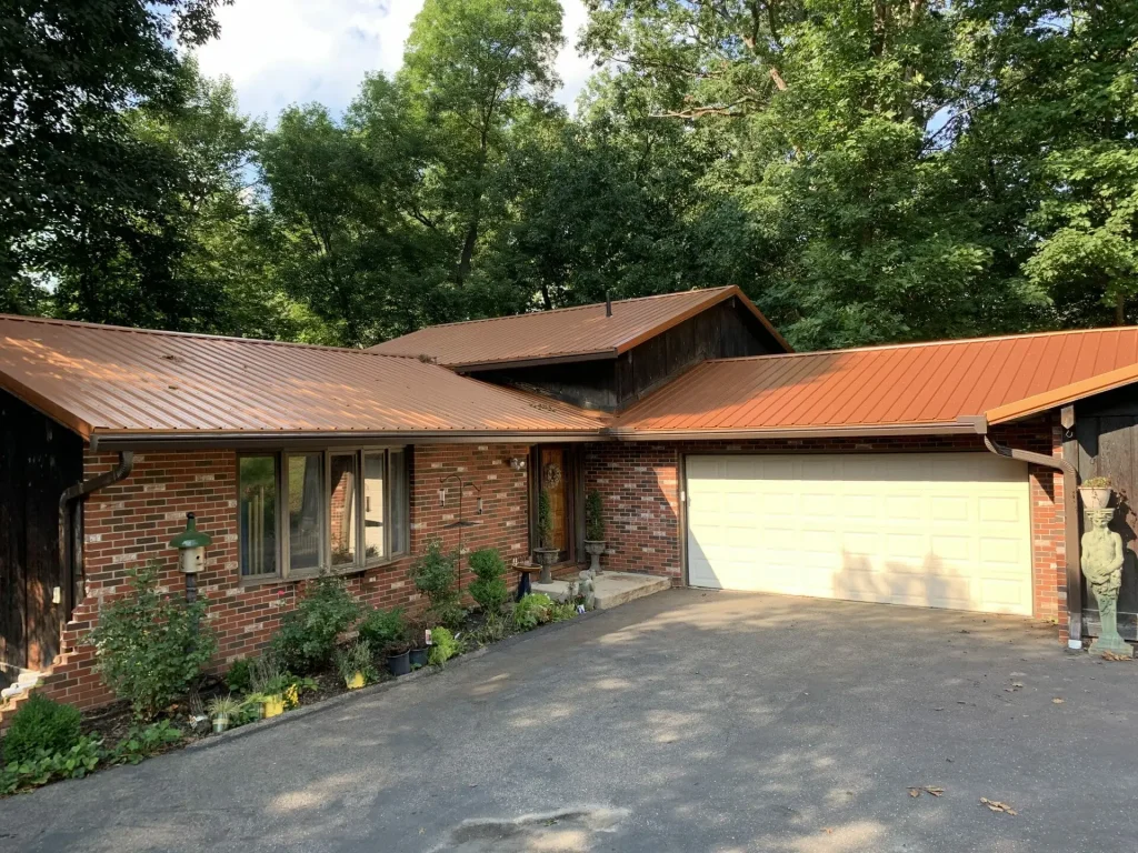 Brick ranch home with copper-tone K-Guard gutters
